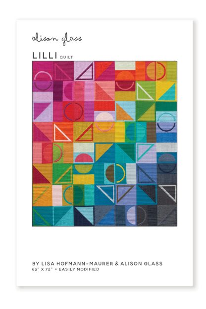 Photo showing the Lilli Quilt sewing pattern from Alison Glass on The Fold Line. A quilt pattern made in quilting cotton fabrics, featuring a design of squares, circles, arcs, and triangles in a rainbow of colours.