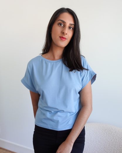 Woman wearing the Naya T-shirt sewing pattern from Tammy Handmade on The Fold Line. A Tee pattern made in viscose jersey, cotton jersey, or lightweight knit wool blends fabrics, featuring a loose boxy fit, short grown-on sleeves with cuff, and round neck.