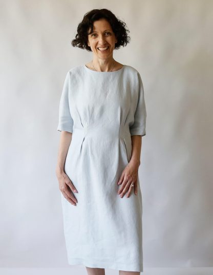 Woman wearing the Day Dress sewing pattern from The Maker’s Atelier on The Fold Line. A dress pattern made in cotton, linen, denim, chambray, Tencel and viscose fabrics, featuring a relaxed fit, pull-on style, grown on elbow length sleeves, round neck, front and back bodice and waist darts, and below knee length hem.