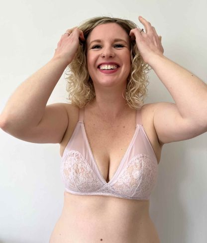 Woman wearing the Willow Soft Cup Bra (Full Bust) sewing pattern from Sew Projects on The Fold Line. A bra pattern made in cotton, rigid lace, rigid tulle, rigid embroidery, satin, duoplex fabrics, featuring high rigid cups, stretch neckline, adjustable shoulder straps and double hook and loop back closure.