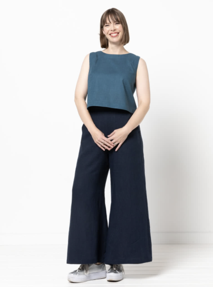 Woman wearing the Loddon Woven Pant sewing pattern from Style Arc on The Fold Line. A trouser pattern made in washed linen, crepe, viscose or fine wool fabrics, featuring a pull-on style, wide legs, angled pockets, flat front waistband elasticated at sides and back, sits on natural waist.