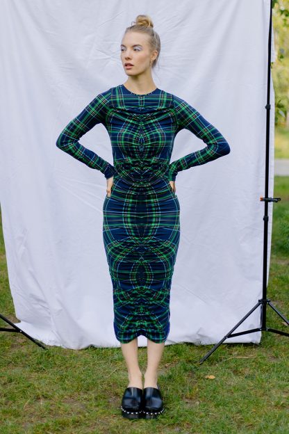 Woman wearing the Vero Dress sewing pattern from JULIANA MARTEJEVS on The Fold Line. A knit dress pattern made in cotton jersey fabrics, featuring long sleeves, round neckline, close fit, midi length and full length gathered centre front.