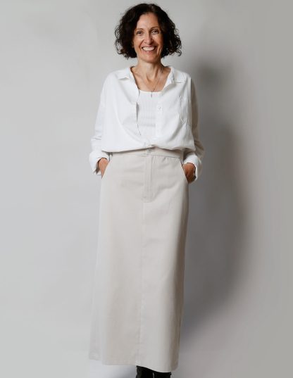 Woman wearing the Maxi Skirt sewing pattern from The Maker’s Atelier on The Fold Line. A skirt pattern made in cottons, linens, denim, or wool suiting fabrics, featuring a maxi length, fly front fastening, front slash pockets, back patch pockets, and high kick pleat.