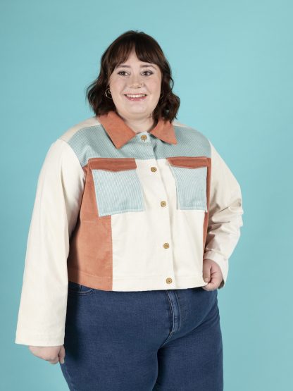 Woman wearing the Sonny Jacket sewing pattern from Tilly and the Buttons on Fold Line. A jacket pattern made in denim, twill, canvas, corduroy, jacquard or wool fabrics, featuring a boxy fit, drop shoulders, pointed collar, front and back yokes, chest pockets with flaps, and cropped length.