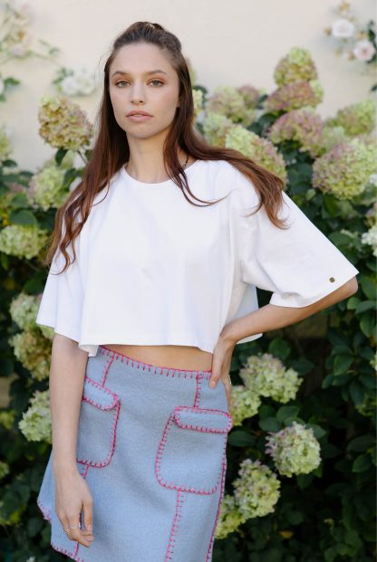 Woman wearing the Cropped T-shirt sewing pattern from JULIANA MARTEJEVS on The Fold Line. A T-shirt pattern made in cotton jersey fabrics, featuring an oversized fit, cropped length and round neck.