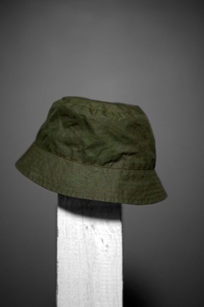 Photo showing the Free Bucket Hat sewing pattern from Merchant & Mills on The Fold Line. A hat pattern made in oilskin, dry oilskin, mid weight cotton canvas or drill, or mid weight denim fabrics, featuring a lining, decorative band, stitching details and binding around the brim.