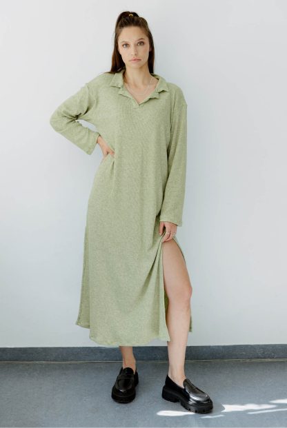 Woman wearing the Riley Dress sewing pattern from JULIANA MARTEJEVS on The Fold Line. A dress pattern made in knit fabrics, featuring a relaxed fit, midi length, polo collar, long sleeves, and side slits.