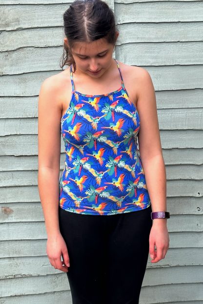 Teen wearing the Teen Girls' Olympia Sports Top sewing pattern from Waves & Wild on The Fold Line. A sports top pattern made in light to medium weight knit swim Lycra fabrics, featuring a close-fit, full length, straight front, and racer back.