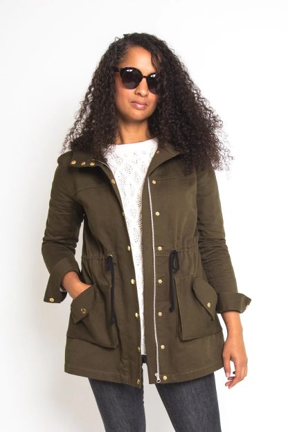 Woman wearing the Kelly Anorak sewing pattern by Closet Core Patterns. An anorak jacket pattern made in twill, gabardine, linen, ripstop or Gore-Tex fabric featuring an optional drawstring waist, zipper placket with snap buttons, roomy hood, and pockets.