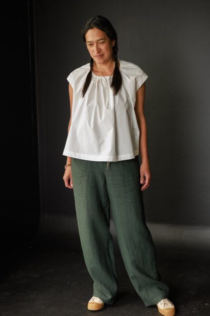 Woman wearing the 101 Trousers sewing pattern by Merchant and Mills. A trouser pattern made in linen, soft cottons, fine wool or crepe fabric featuring a drawstring waist, side pockets, and false fly.