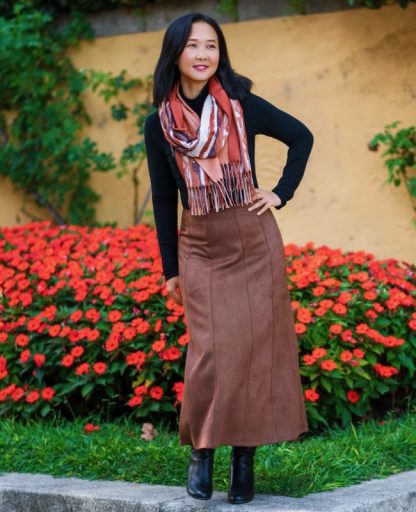Women wearing the Quebrada Skirt sewing pattern from Itch to Stitch on The Fold Line. A gored skirt pattern made in denim, twill, corduroy and heavy-weight linen fabrics, featuring an A-line silhouette, midi length, center back zip closure, and waist facings.
