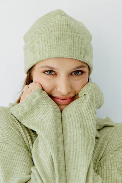 Woman wearing the Sophie Beanie sewing pattern from JULIANA MARTEJEVS on The Fold Line. A hat pattern made in knit or jersey fabrics, featuring a pull on style, snug fit and turn back hem.