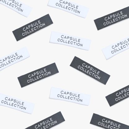 Photo showing ‘Capsule collection’ Labels from Kylie & The Machine on The Fold Line. A washable, durable, and non-scratchy label. Included are 6 woven labels: 3 x white background with black text and 3 x black background with white text background. They are all ready to be sewn into your handmade clothes.