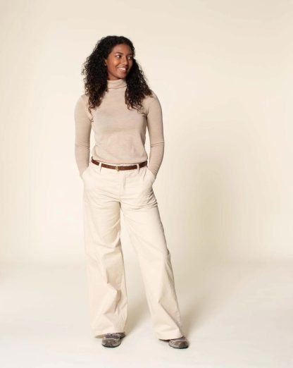Woman wearing the Hepburn Pants sewing pattern from Wardrobe by Me on The Fold Line. A trouser pattern made in cotton, linen, canvas or denim fabrics, featuring a front zip fly, side pockets, back welt pockets, waistband with five belt loops and wide legs.