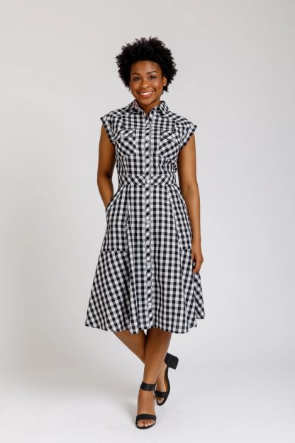 Woman wearing the Matilda Dress sewing pattern from Megan Nielsen on The Fold Line. A shirt dress pattern made in cotton, linen, chambray, rayon, tencel, or silk fabrics, featuring princess seams, drop shoulder, sleeveless, front button closure, back yoke, pleated breast pockets, A-line skirt with patch pockets, collar and stand, midi length.