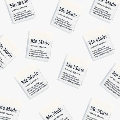 Photo showing ' Me Made' Woven Labels from Kylie & The Machine on The Fold Line. A washable, durable and non-scratchy fabric label featuring a cream background, and the word 'Me Made' in black text all ready to be sewn into your handmade clothes.
