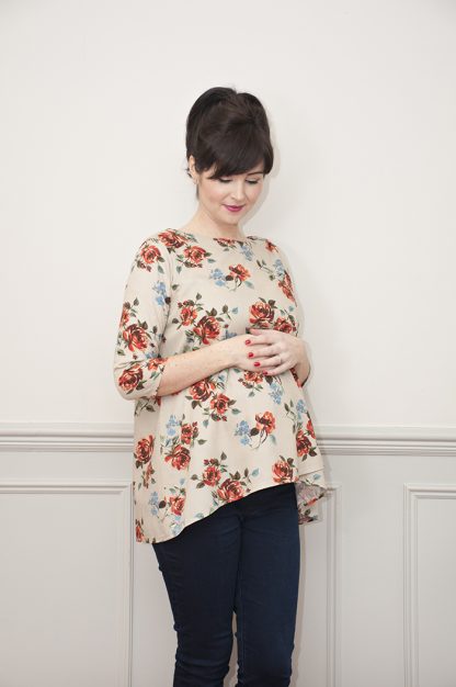 Woman wearing the Lily Maternity Top sewing pattern from Sew Over It on The Fold Line. A top pattern made in rayon, viscose, or crepe fabric, featuring a double-layer front also suitable for nursing, round neck, and 3/4 length sleeves.