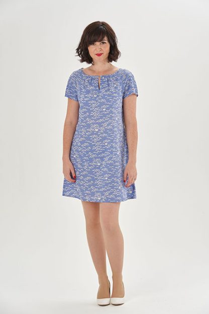 Woman wearing the Lulu Dress sewing pattern from Sew Over It on The Fold Line. A dress pattern made in cotton, cotton lawn, rayon, or crepe fabric, featuring a loose, slightly A-line fit, raglan sleeves, and a gathered neckline with a keyhole detail.