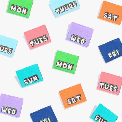 Photo showing 'Mon 2 Sun' Labels from Kylie & The Machine on The Fold Line. A washable, durable, and non-scratchy label. Included are 7 woven labels: choose the day of the week or a playful icon. They are all ready to be sewn into your handmade clothes.