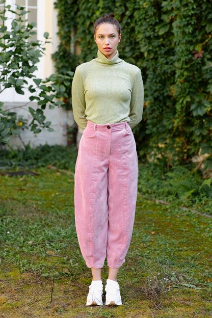 Woman wearing the Quinn Pants sewing pattern from JULIANA MARTEJEVS on The Fold Line. A trouser pattern made in denim or corduroy fabrics, featuring a loose fit at the hip and thigh, tapers towards the ankle, zip fly, front pockets, and belt loops.