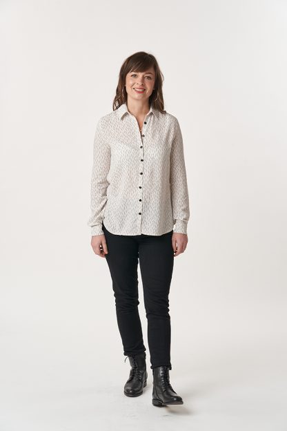 Woman wearing the Ultimate Shirt sewing pattern from Sew Over It on The Fold Line. A shirt pattern made in cotton lawn, poplin, rayon, viscose linen, or shirting fabrics, featuring a dartless bodice, collar and collar stand, back yoke with an inverted box pleat, traditional shirt cuffs with bound cuff plackets, grown-on button stands, and a curved hem.