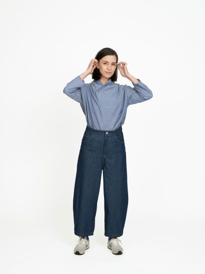 Woman wearing the Barrel-leg Trousers sewing pattern from The Assembly Line on The Fold Line. A trousers pattern made in twill or denim fabric, featuring a dropped crotch, cropped curved leg, zip fly, and front and back pockets.