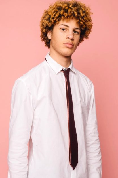 Photo of a man wearing the Henrik Tie sewing pattern from Melilot on The Fold Line. A tie pattern made in cotton, wool, silk or rayon fabrics, featuring a reversible design and narrow silhouette.