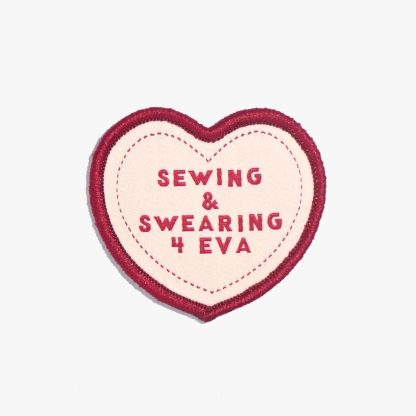 Photo of the ‘Sewing & Swearing 4 Eva’ iron-on patch from Kylie & The Machine on The Fold Line. An heart-shaped patch in red and pink ready to be attached to your handmade garment or bag.