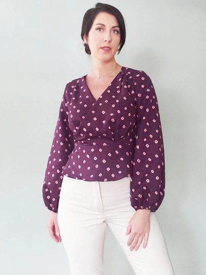 Woman wearing the Romy Wrap Expansion Pack sewing pattern from Pattern Scout on The Fold Line. A top pattern made in tencel, lyocell, rayon, crepe de chine, linen, chambray, poplin, or voile fabric, featuring a v-neck, wrap front, and full-length bishop sleeves.