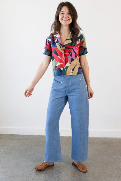 Woman wearing the Buttress Jeans sewing pattern from Allie Olson on The Fold Line. A jeans pattern made in denim, canvas, twill, or corduroy fabric, featuring a high waist, front yoke, hidden slit pockets, back pockets, wide leg, and fly zip.