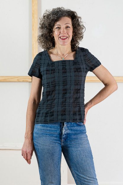 Woman wearing the Laureles Square-neck Top sewing pattern from Liesl + Co on The Fold Line. A pull-on top pattern made in cotton voile, lawn, poplin, chambray, or linen fabric, featuring a square neck, princess seams, and short sleeves.