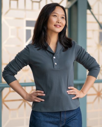 Woman wearing the Venado Top sewing pattern from Itch to Stitch on The Fold Line. A knit top pattern made in jersey, interlock, or lightweight French terry fabric, featuring a V-neckline, mini shawl collar, front placket with buttons, and long sleeves.