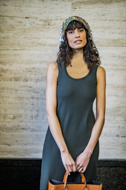 Woman wearing the Yuka Dress sewing pattern from Fibre Mood on The Fold Line. A tank dress pattern made in knit fabrics, featuring a deep round neckline.