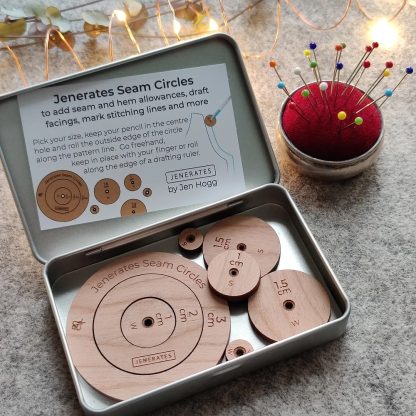 Photo of the Seam Circles from Jenerates on The Fold Line. Use these unique interlocking cherry wood circles to add or subtract seam and hem allowances, in centimetres or inches, on your sewing patterns.