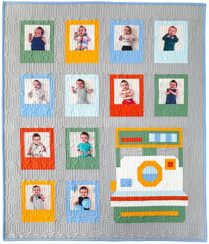 Photo of the Snap Happy Quilt sewing pattern from Pen + Paper Patterns on The Fold Line. A quilt pattern, made in quilting cotton fabric, that is charm square and fat quarter friendly and includes instructions for making baby size and throw size quilts.